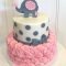 baby shower cake with elephant on top the cake is a pink rosette