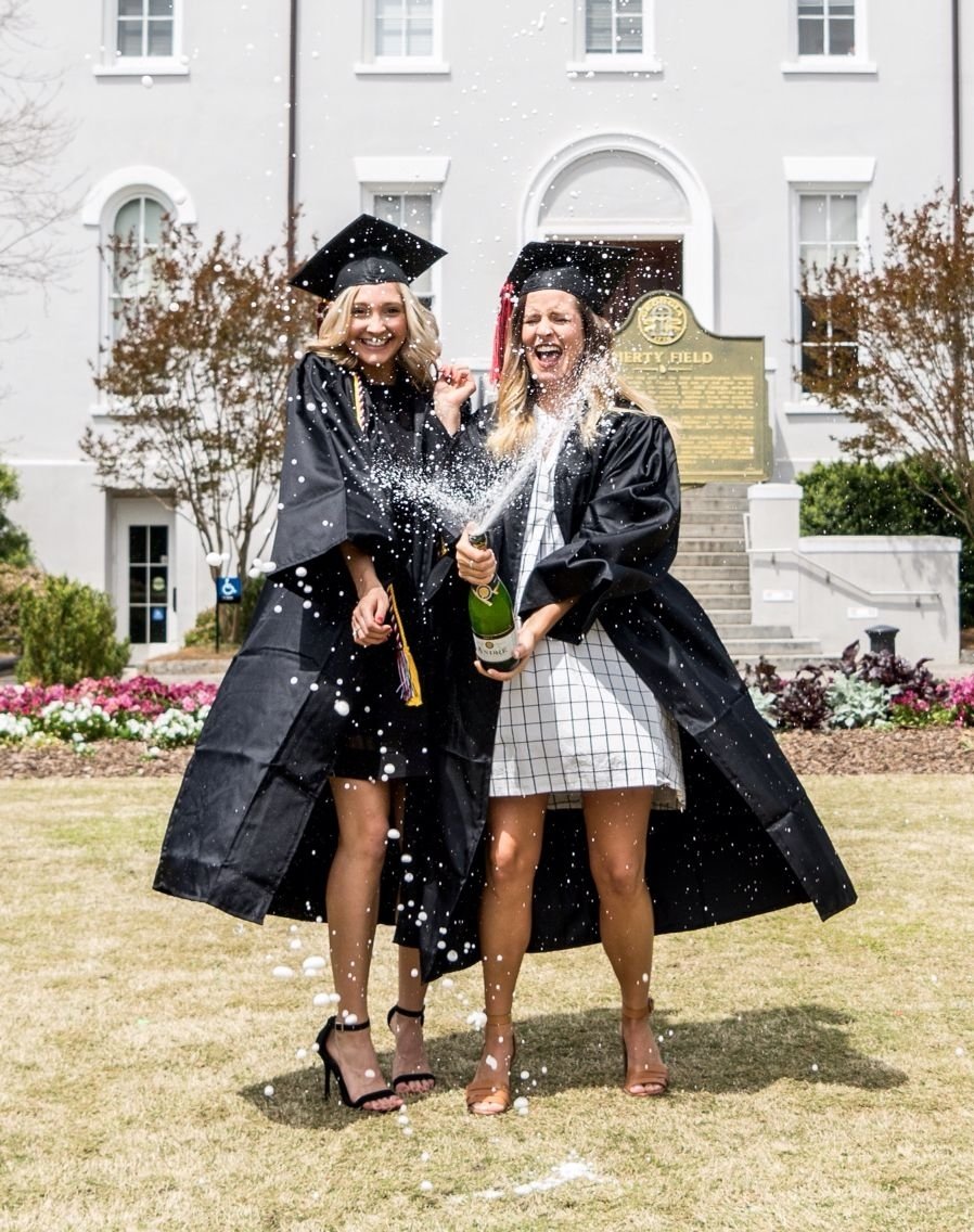 10 Stunning Best Friend Senior Picture Ideas college graduation photos with my best friend popping a bottle of 2022
