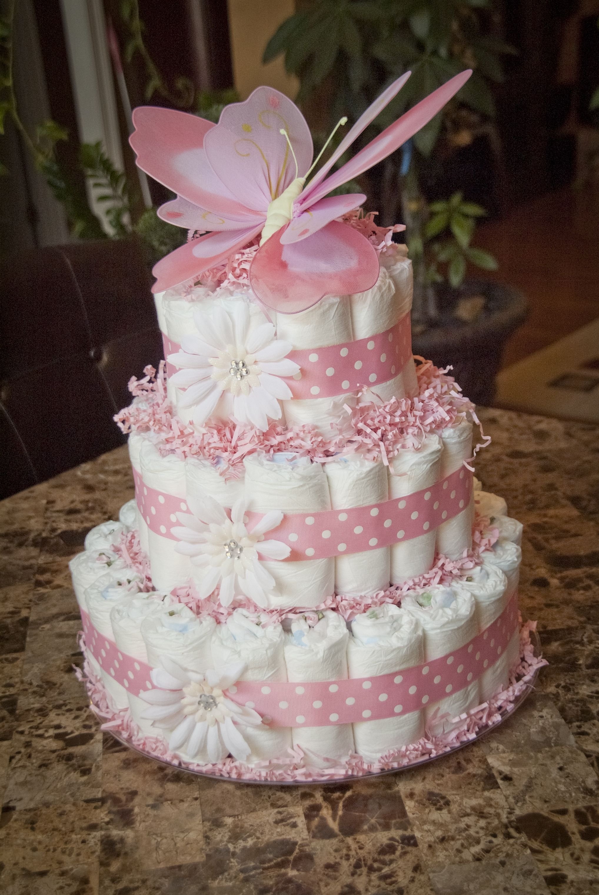 10 Awesome Diaper Cake Ideas For A Girl pink baby girl shower diaper cake topped with butterfly things i 3 2022
